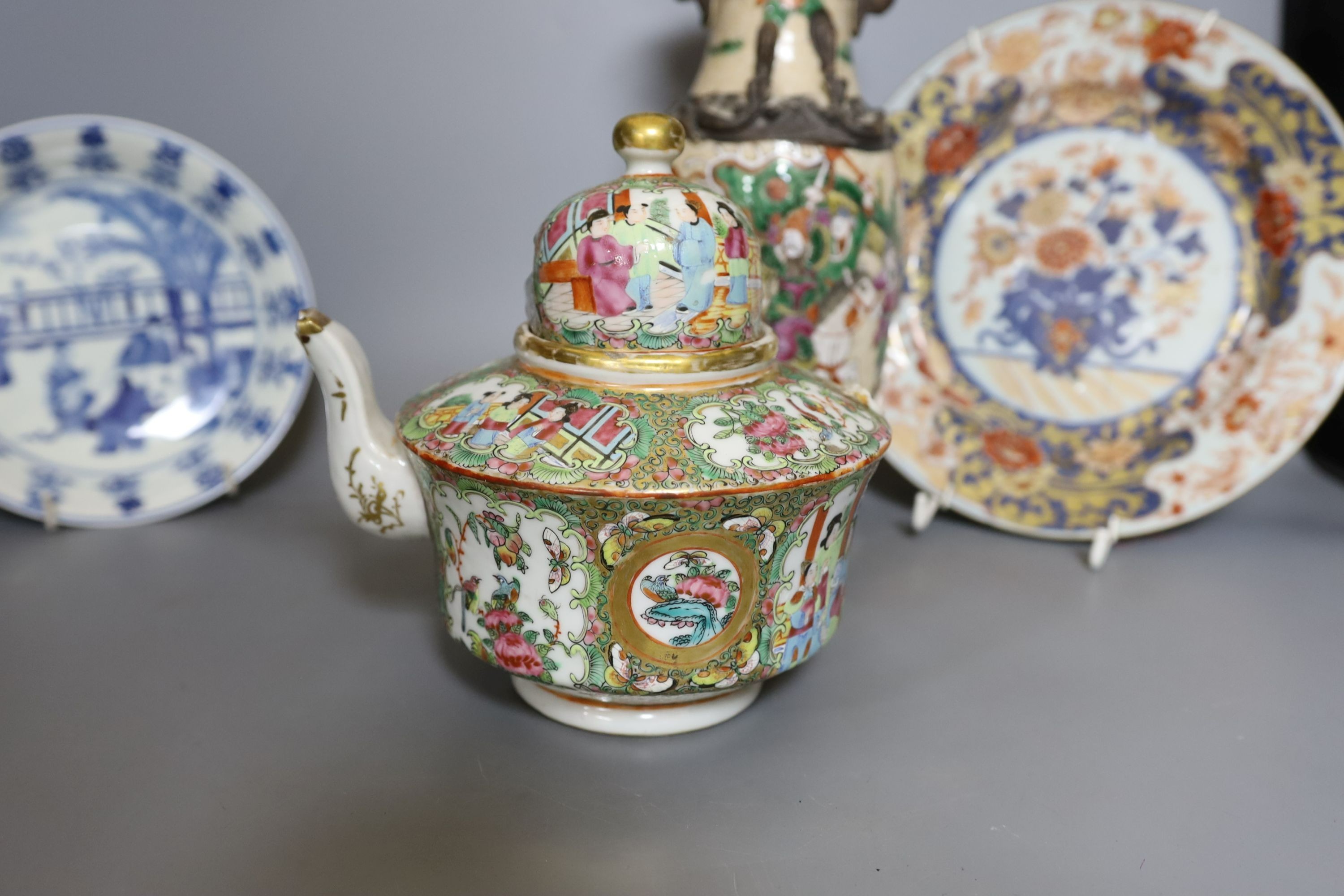 Three Chinese plates including a 19th century Chinese Imari dish, 23cm - repaired, a Chinese famille rose crackleglaze vase, 29cm, together with a famille rose teapot and a crackleglaze celadon ground bottle vase. Talles